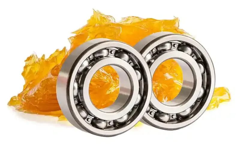 How can you prevent grease from being flushed out of bearings?